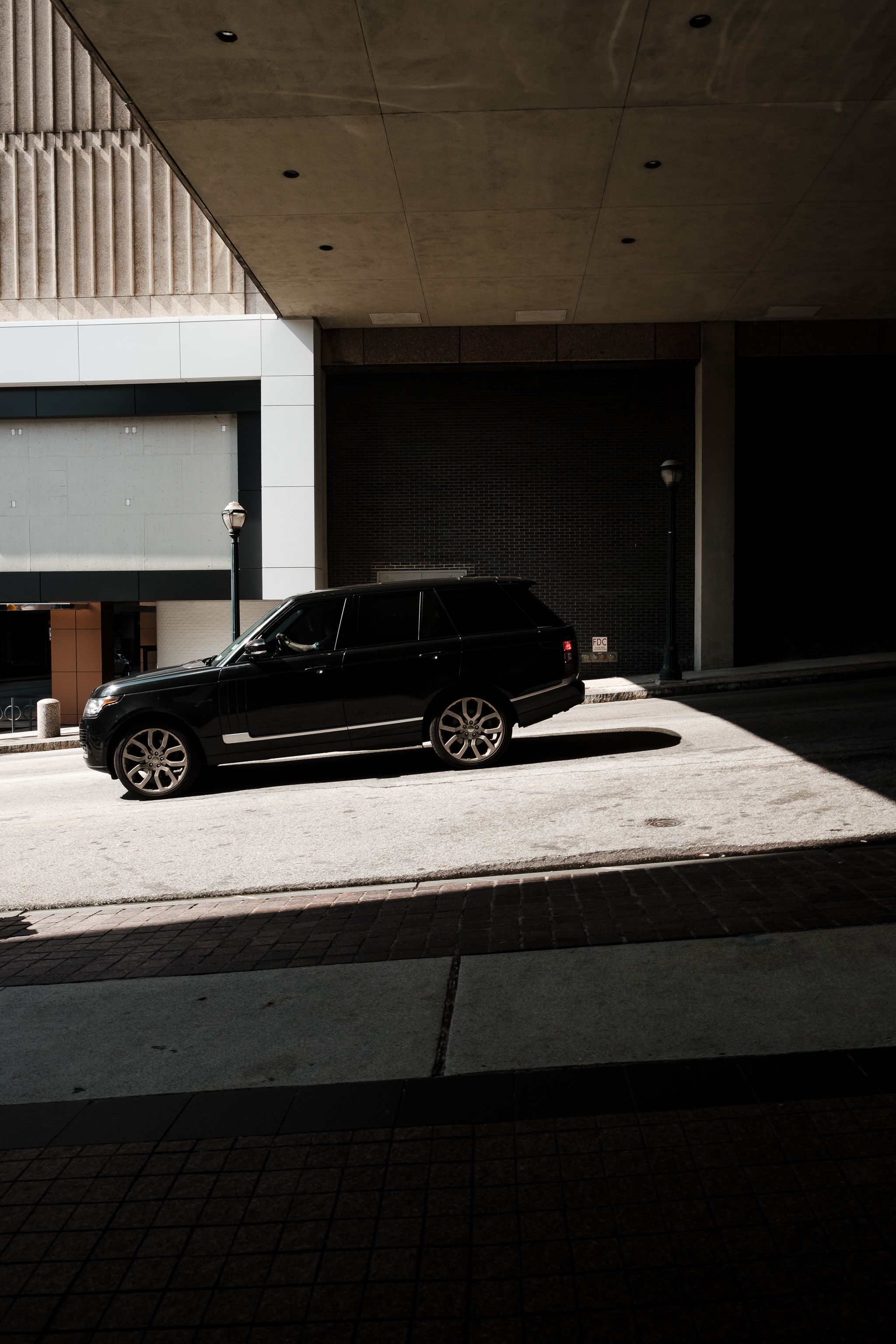 A dark executive vehicle in an urban setting